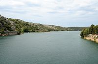 Sight towards the downstream of Krka since the road of Šibenik with Kistanje. Click to enlarge the image in Adobe Stock (new tab).