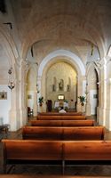 The hermitage of Sant Honorat de Randa Mallorca - Monk praying in the nave of the church. Click to enlarge the image in Adobe Stock (new tab).
