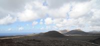 The natural park of los Volcanes in Lanzarote. Caldera Blanca view from the Islote de Hilario. Click to enlarge the image in Adobe Stock (new tab).