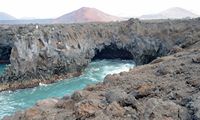 The town of Yaiza in Lanzarote. The Cliffs of Los Hervideros. Click to enlarge the image in Adobe Stock (new tab).